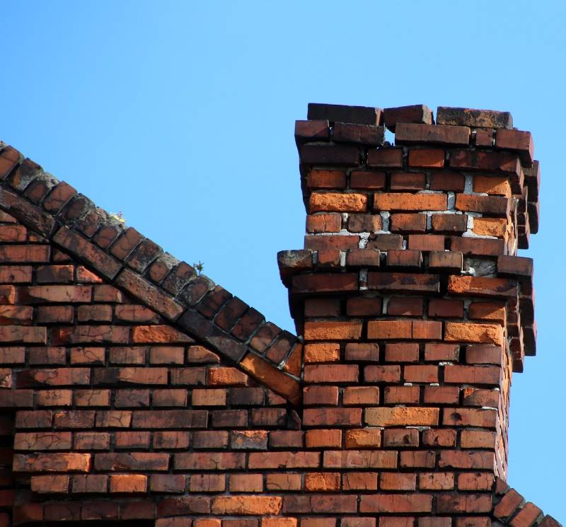 Damaged chimney on an Bel Air home showing cracks and missing mortar